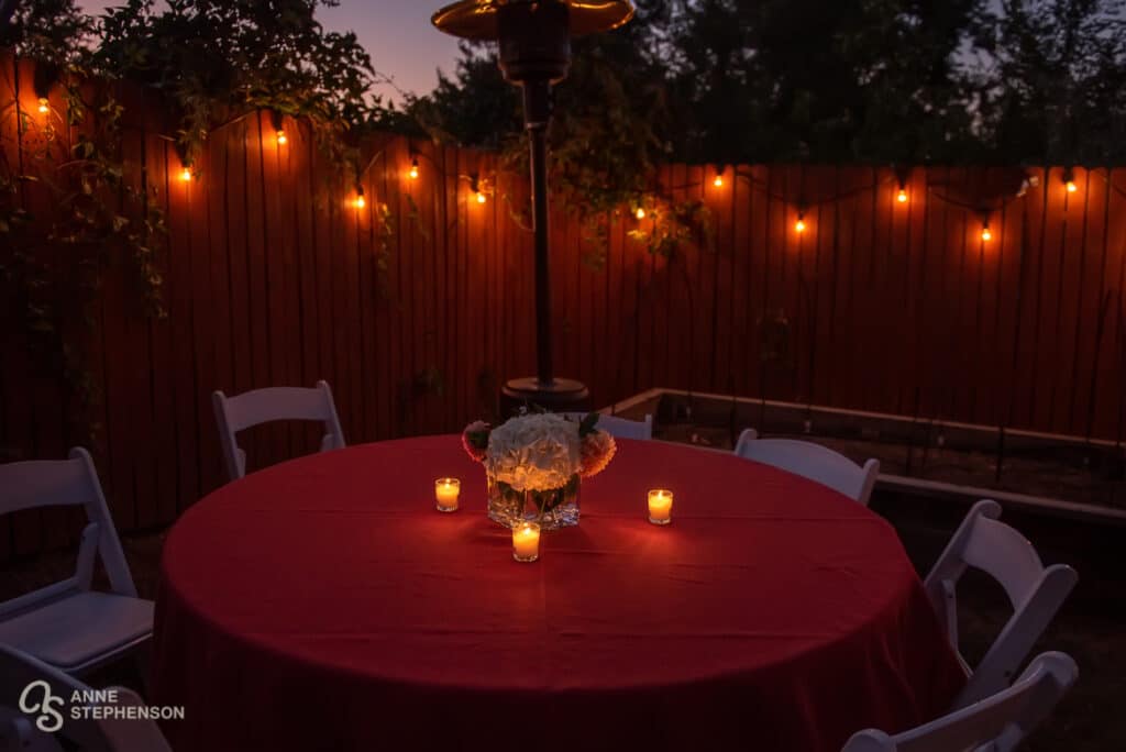 Votive candles and twinkle lights create a beautiful ambiance for the back yard party.
