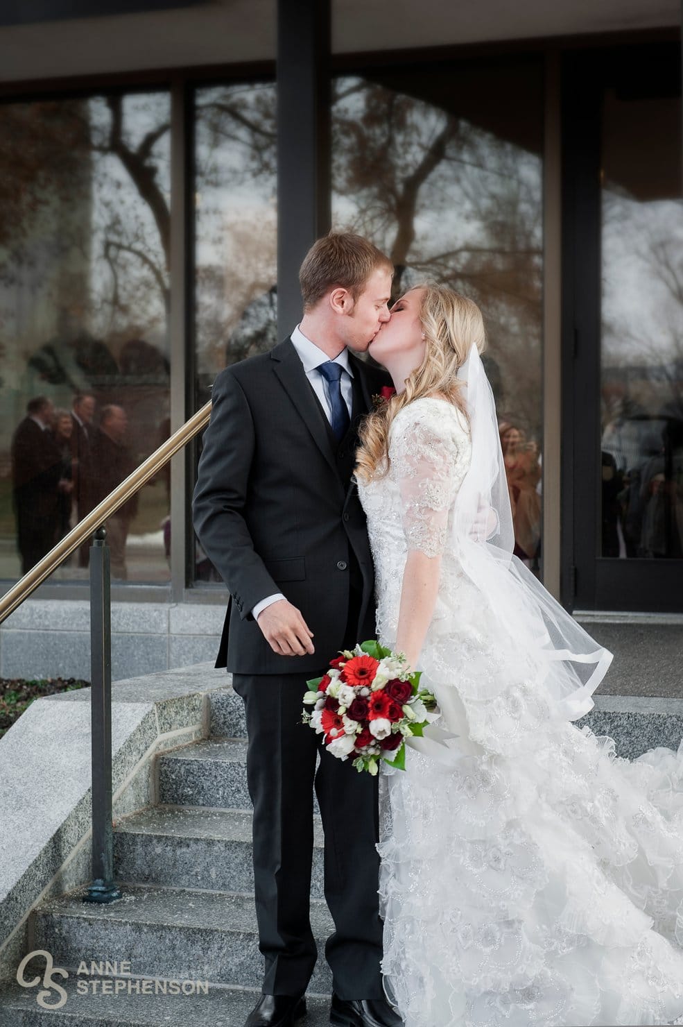 A newly married couple kisses outside the temple in Salt Lake City following their sealing.