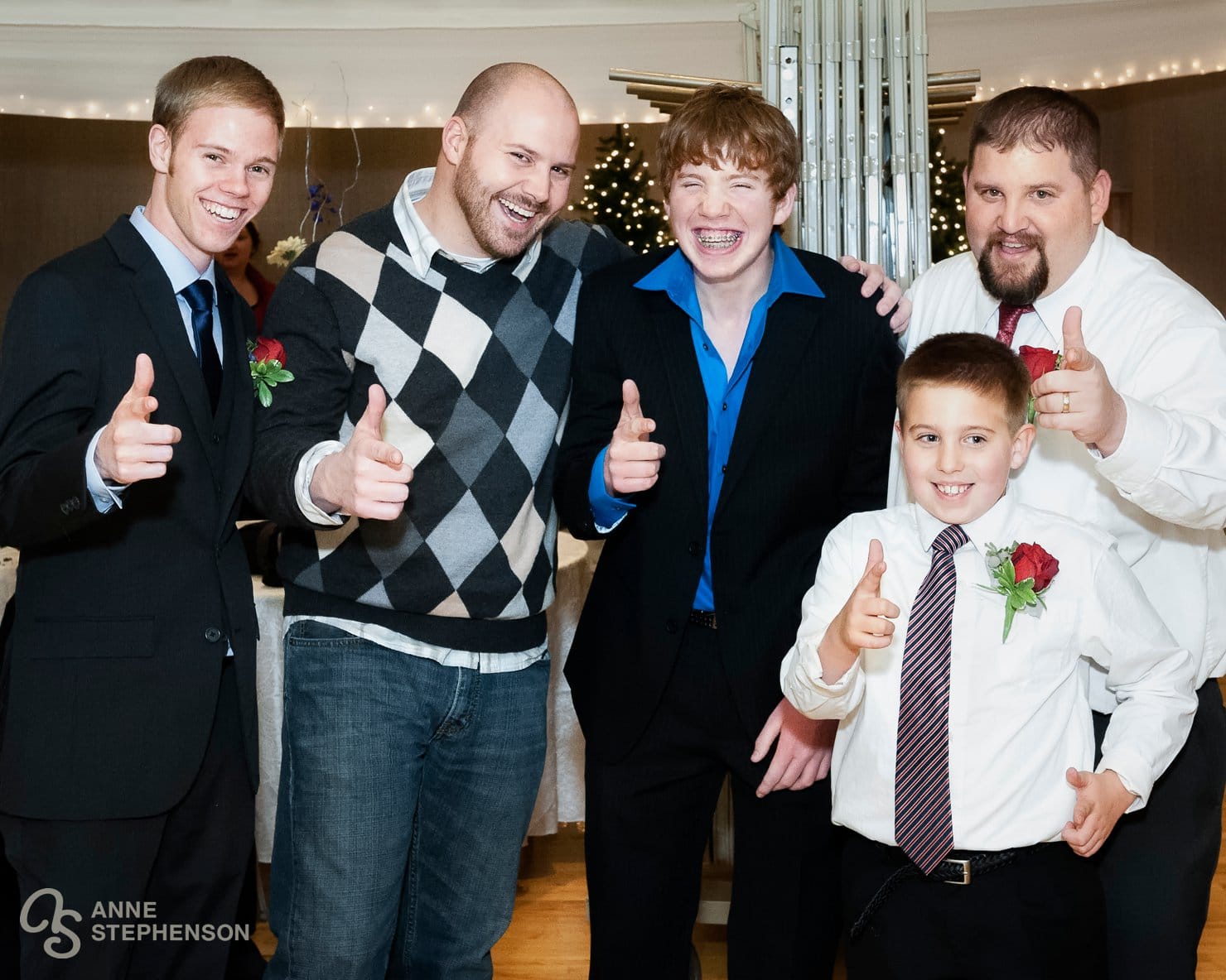 The groom and several male members of his family pose for a photo.