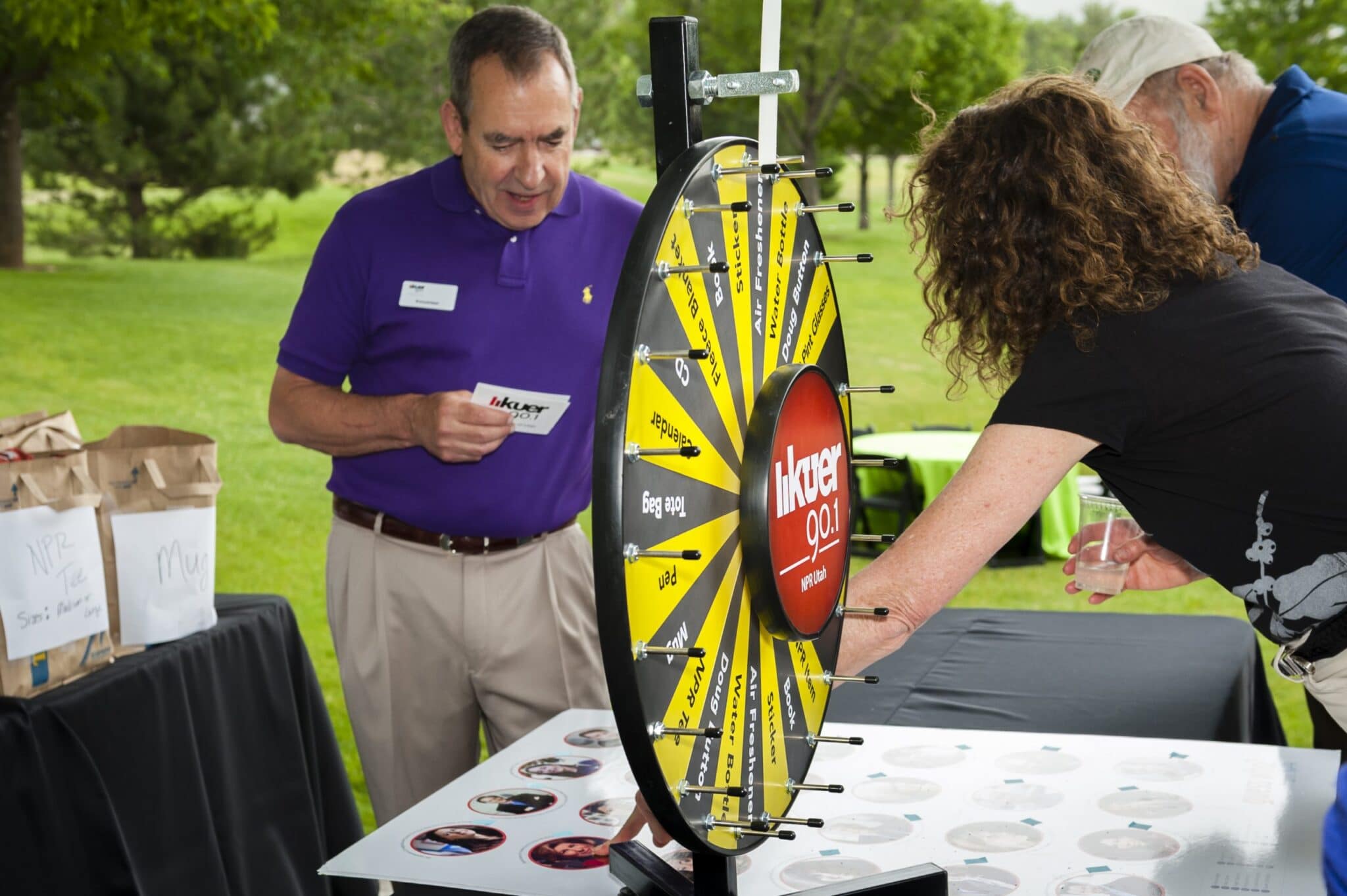 Participants in the KUER Summer Sustainer Bash spin a wheel for prizes.