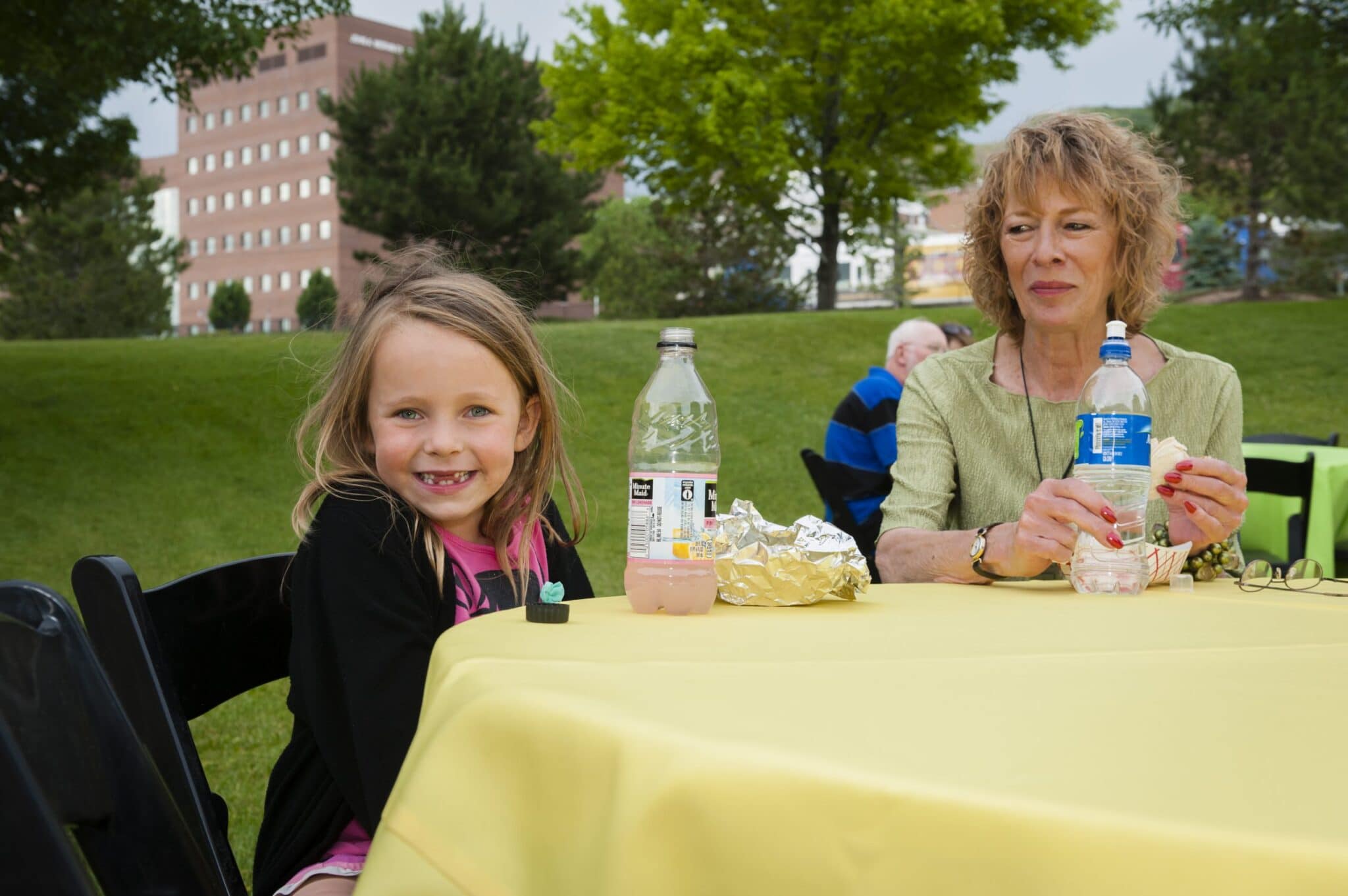 A young girl enjoys time with her grandmother at the KUER Summer Sustainer Bash