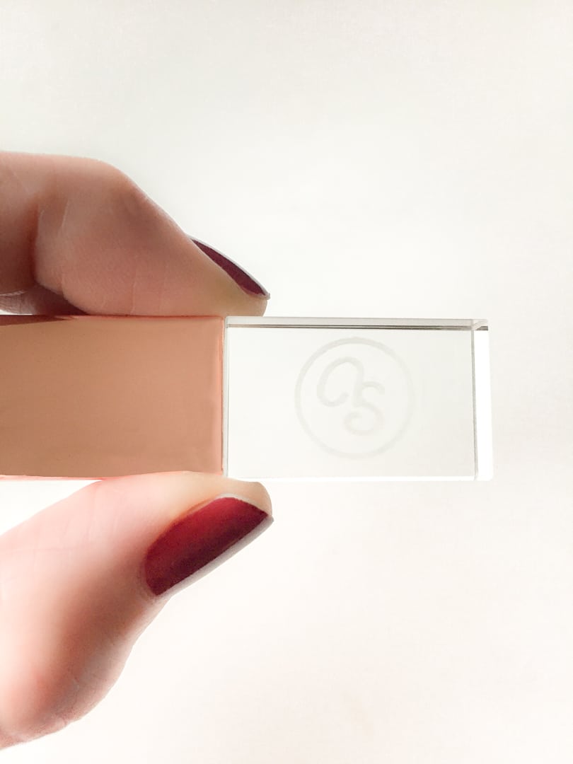 A woman holds a USB Drive.