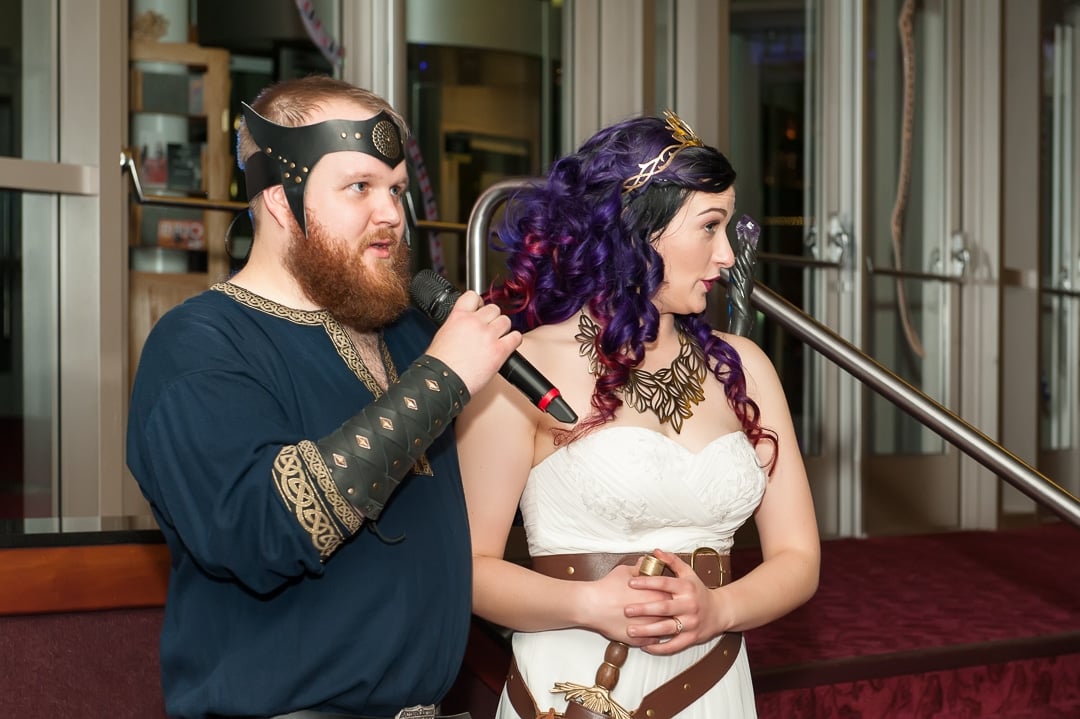 The groom gives a speech prior to the bride tossing glower crowns for the fair maidens in the crowd to catch.