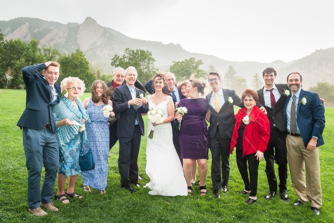 A sudden Boulder rain and windstorm catches this wedding party off guard during their photo session. 