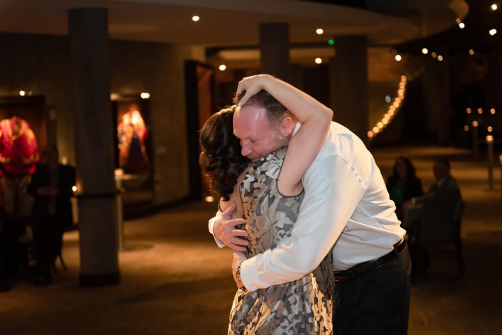A bride and groom share an emotional moment on the dance floor.