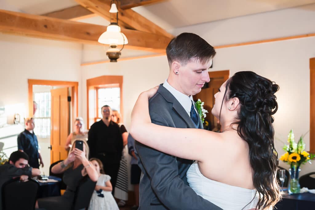 A young newly married couple dance together for the first time after their wedding.
