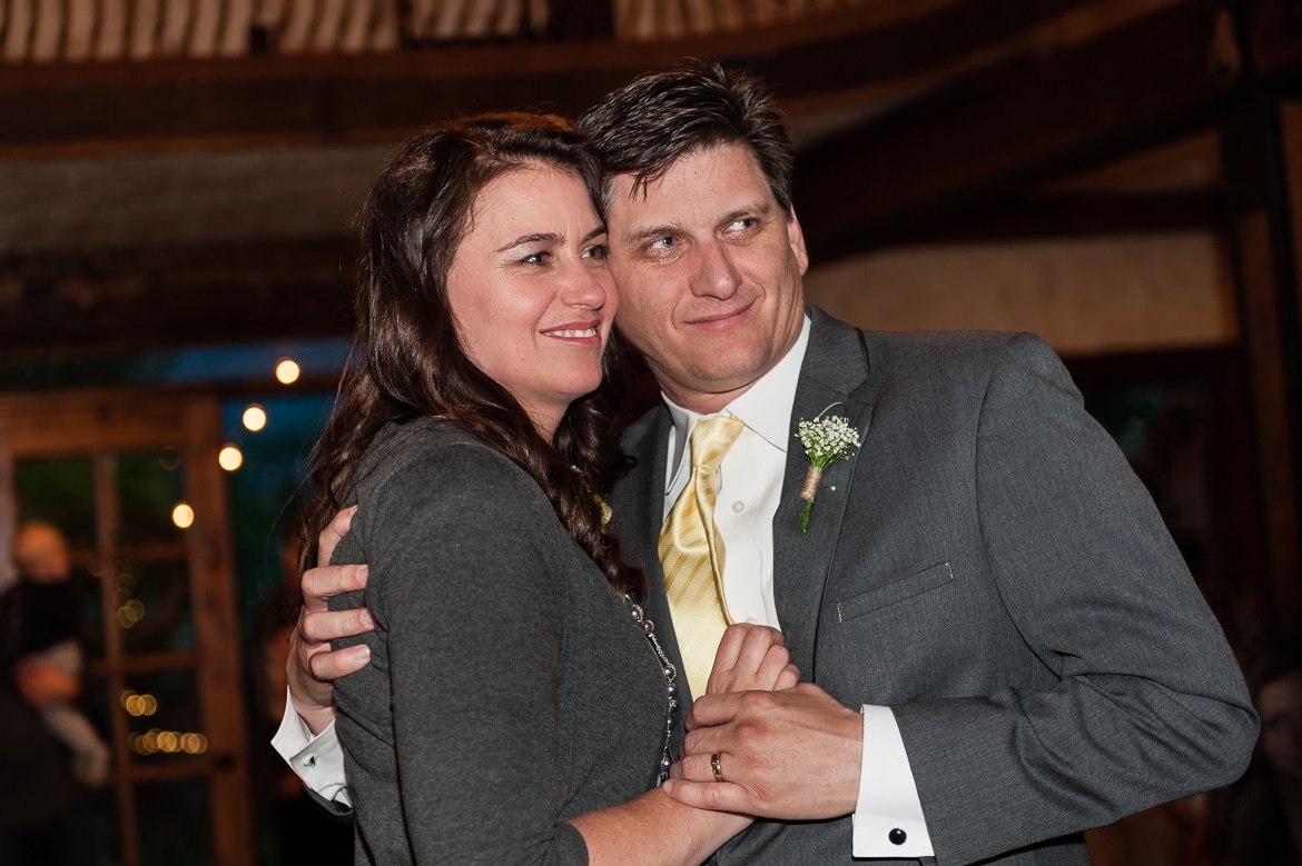 A tearful father of the bride dances with his wife.