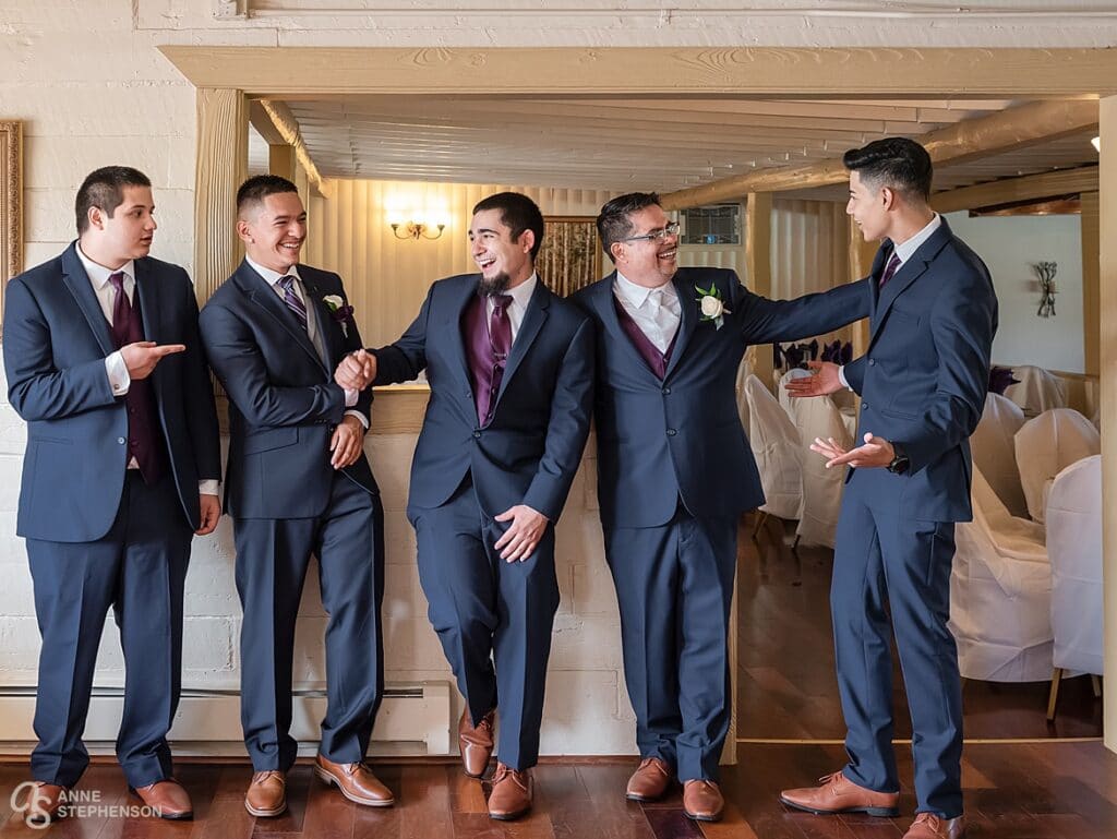 The groom, groomsmen and father of the bride hang out before the start of the ceremony.