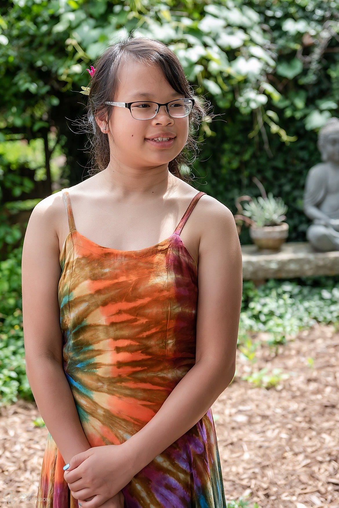 One of the groom's daughters wears a brightly colored tie-dye dress for the wedding.