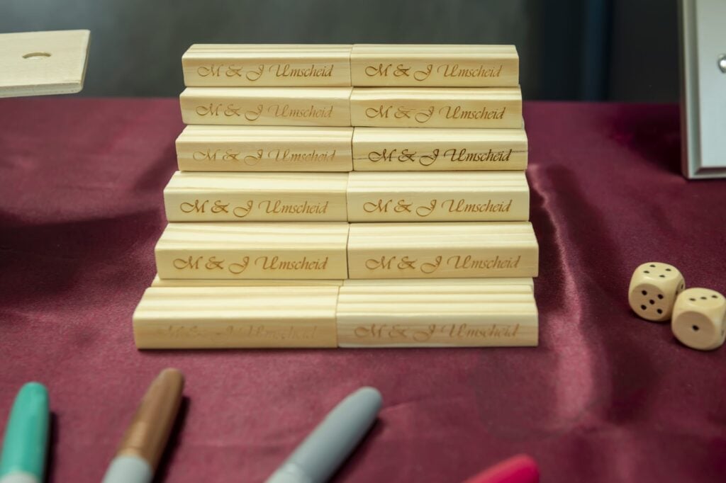 Several pieces of the game Jenga(R) wait to be signed by the wedding guests.