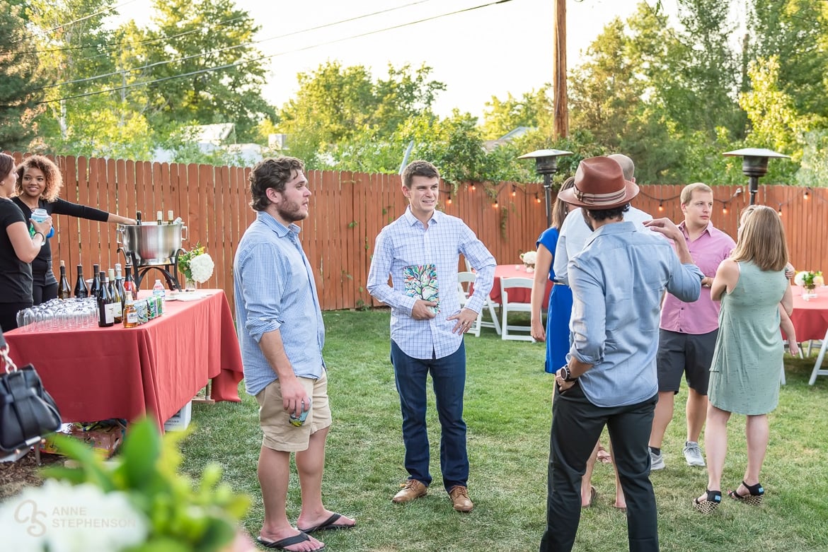 Guests assemble at a friend's house in Boulder, Colorado for a back yard party celebrating the recent wedding of their friends in Chicago.