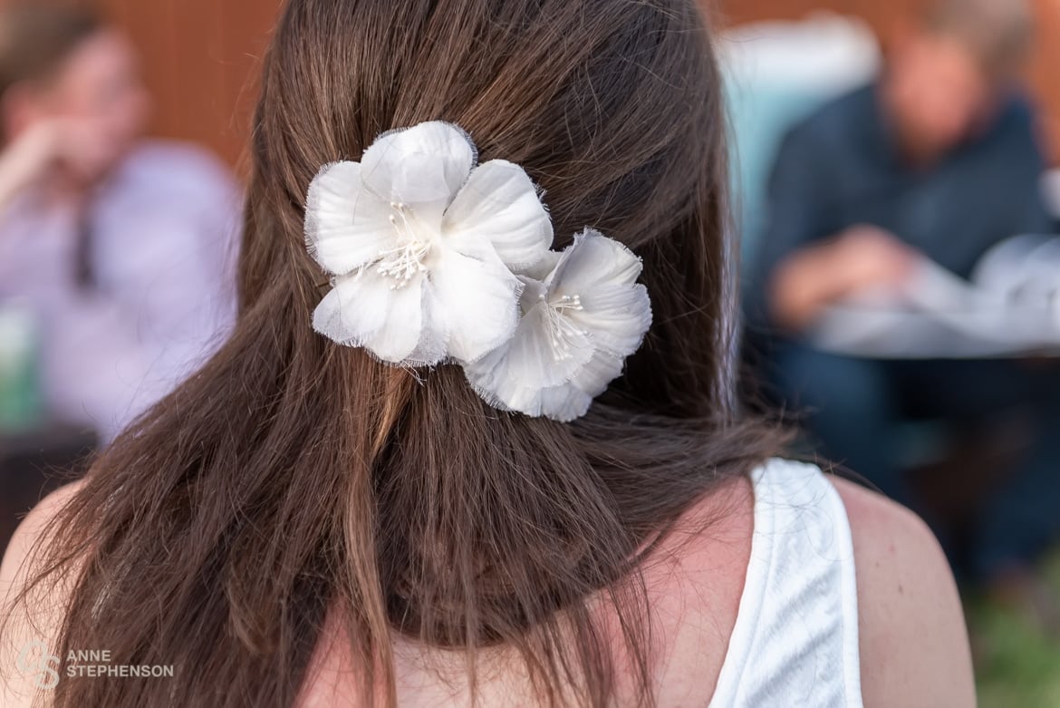 Close up of flowers in the bride's hair repurposed from her mother's wedding dress.