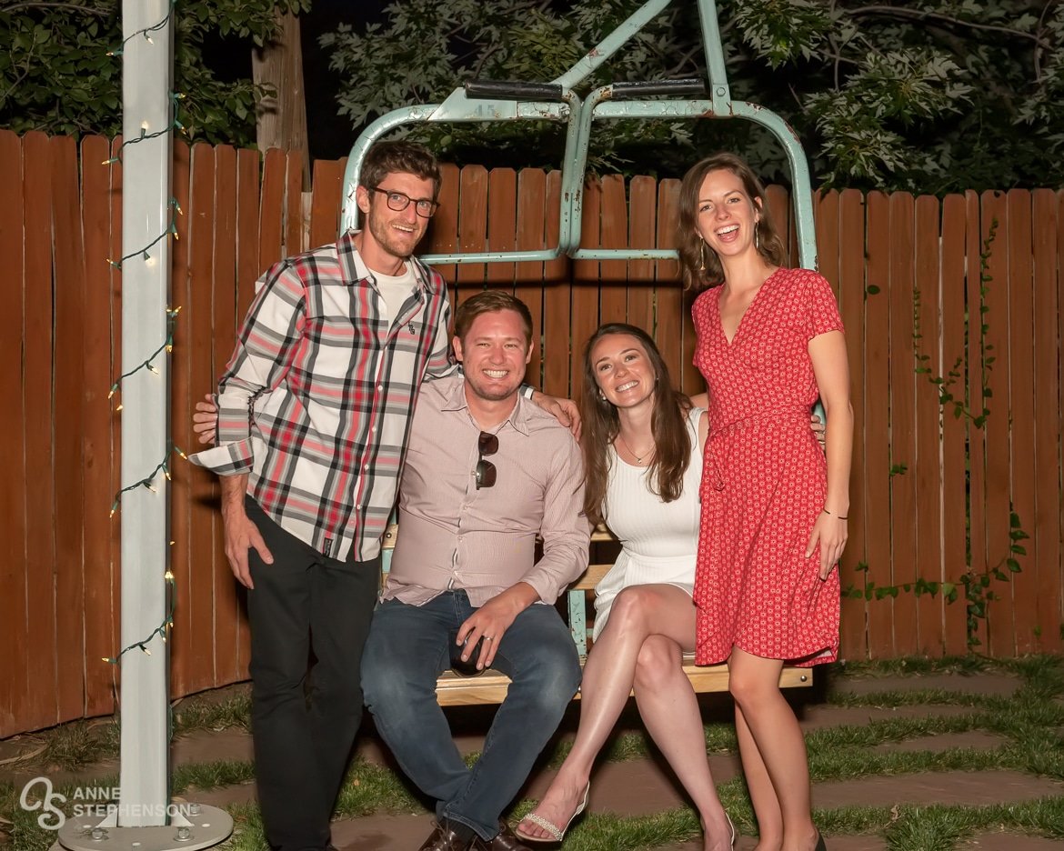 Two couples pose on the historic ski chair where they each received their wedding engagement proposals.