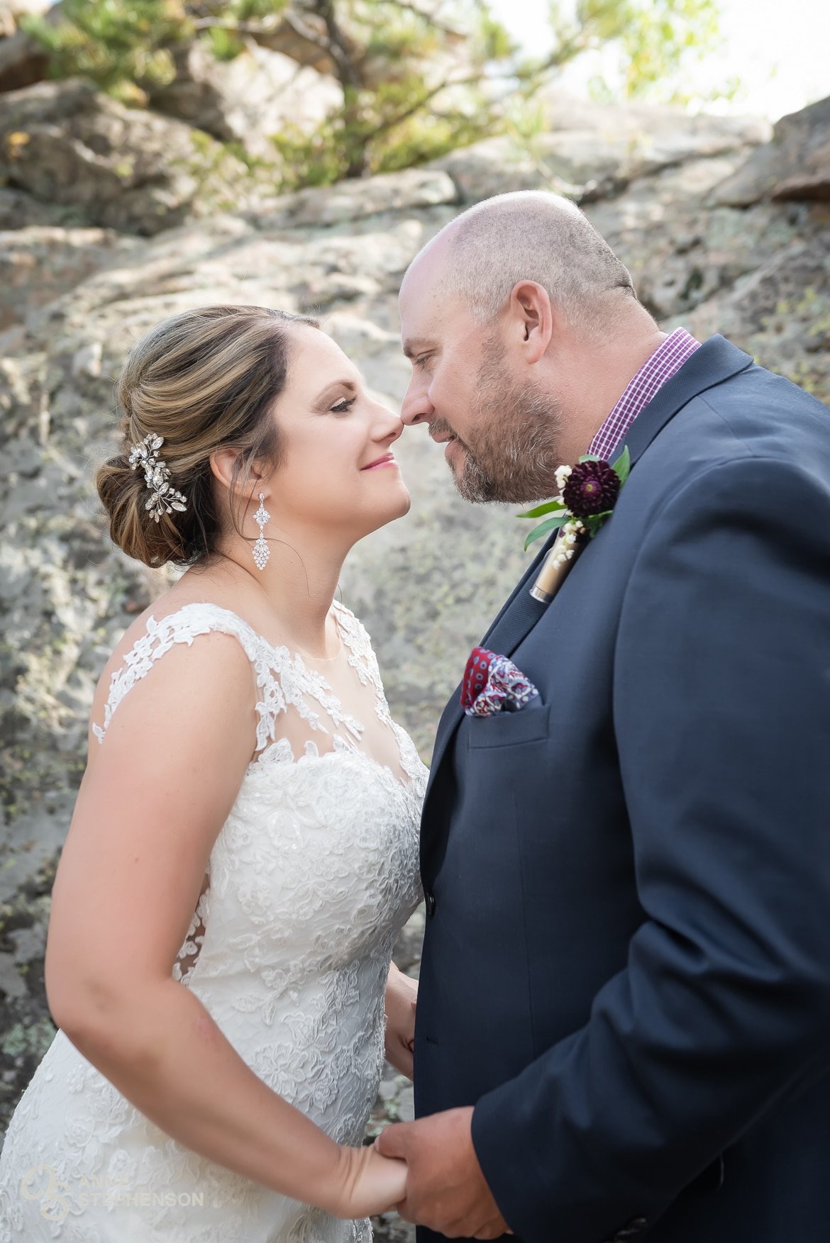 The bride and groom playfully touch noses during their portrait session