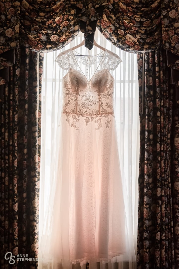 A bridal gown with a hint of pink hangs in the window of the Hotel Boulderado, Boulder.