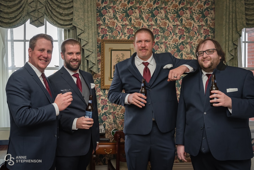 The groom and three groomsmen share a Bud Light beer prior to the ceremony.
