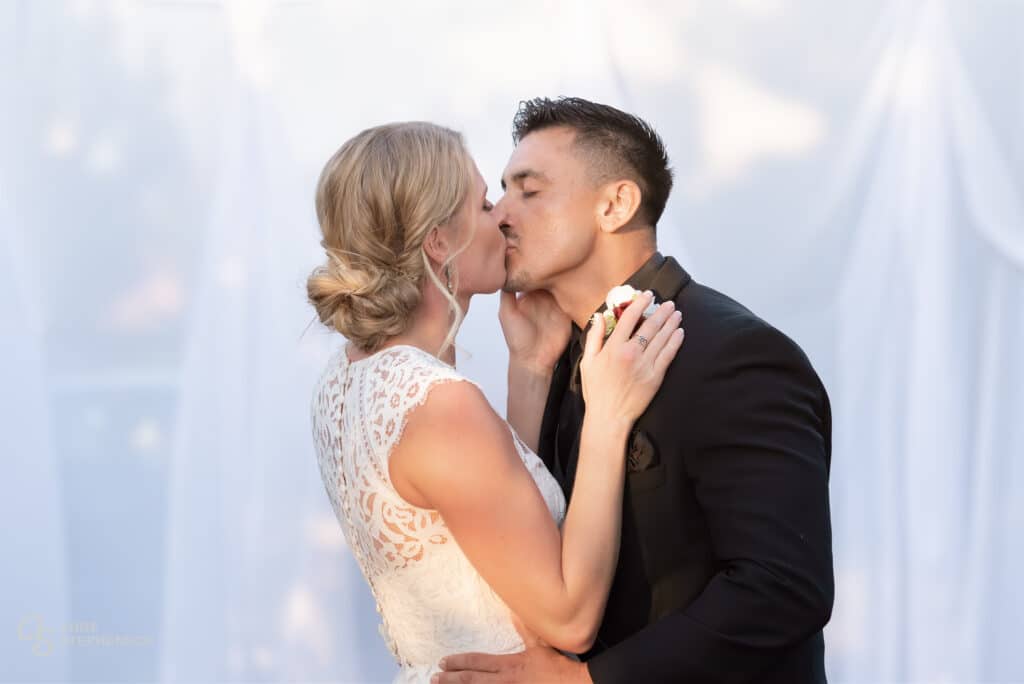 The bride and groom share a much-anticipated first kiss.