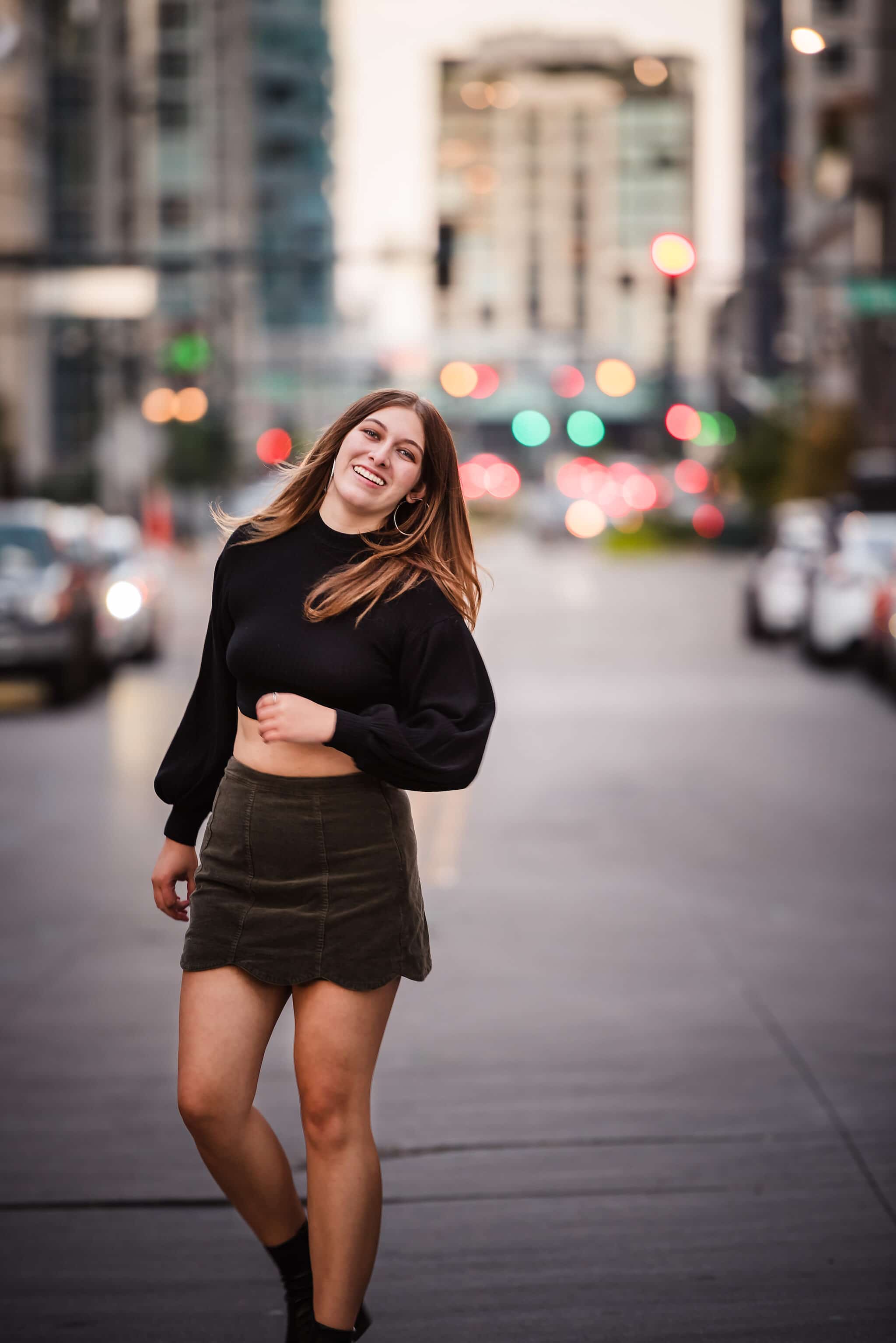 A young woman with street lights behind her in Denver's theater district.