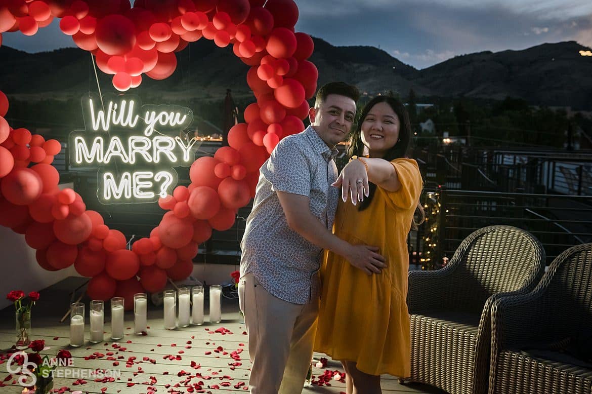 A newly engaged woman and her man shows off her engagement after her surprise proposal.