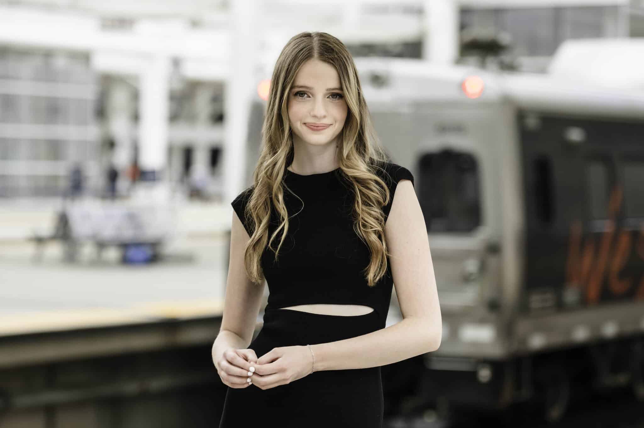 A young woman stands on the platform at Union Station, downtown Denver.