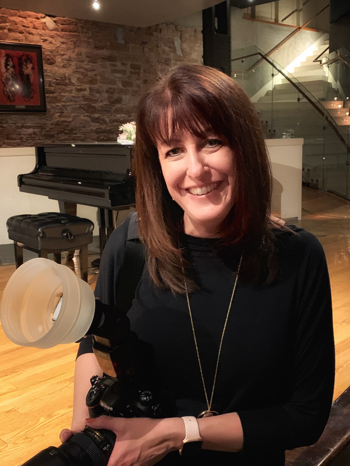 Anne Stephenson holds her camera gear at the ready during a downtown Denver wedding.