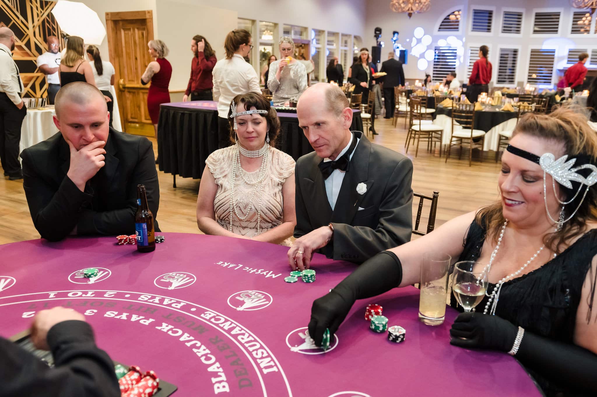Guests at a surprise 40th birthday party enjoy playing blackjack for prizes.