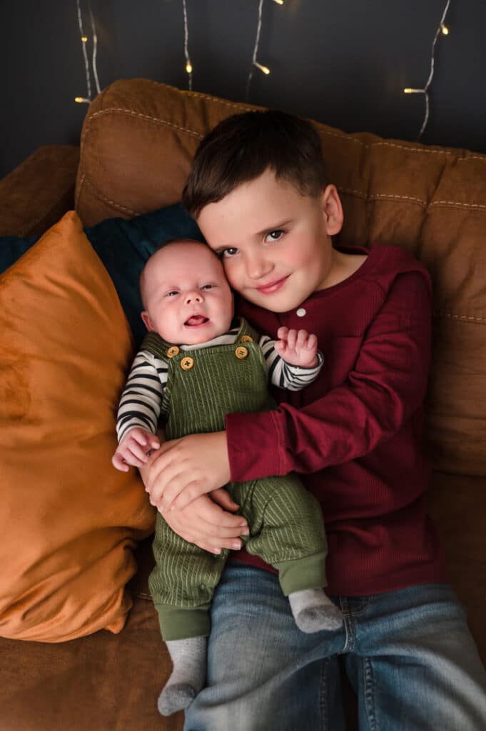 A proud older brother holds the newest addition to the family.