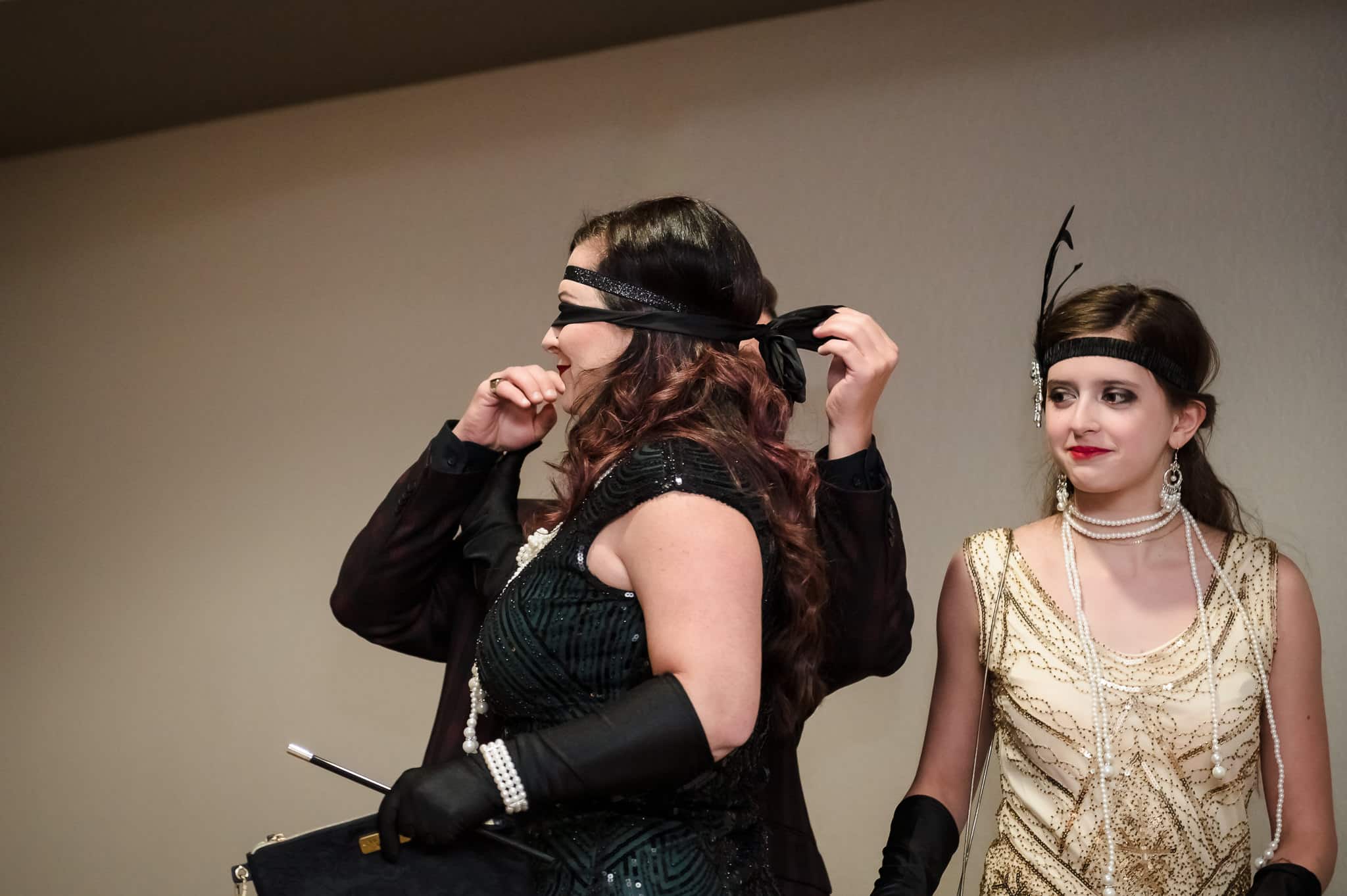 The guest of honor has her blindfold removed at her 40th birthday party.