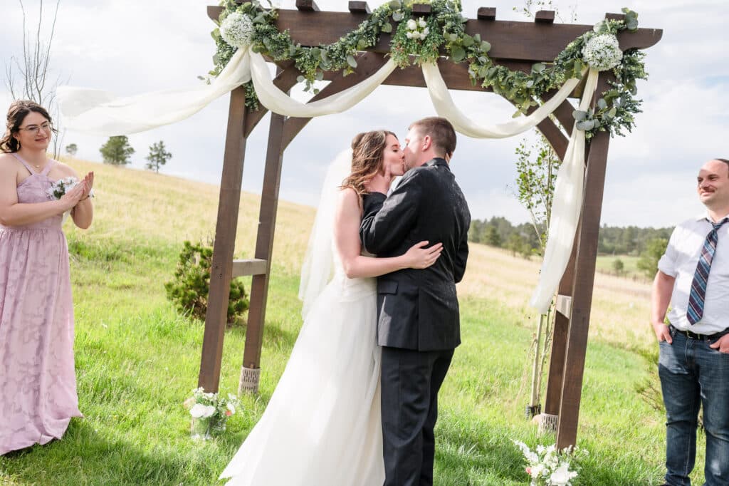 Wedding couple share their first kiss
