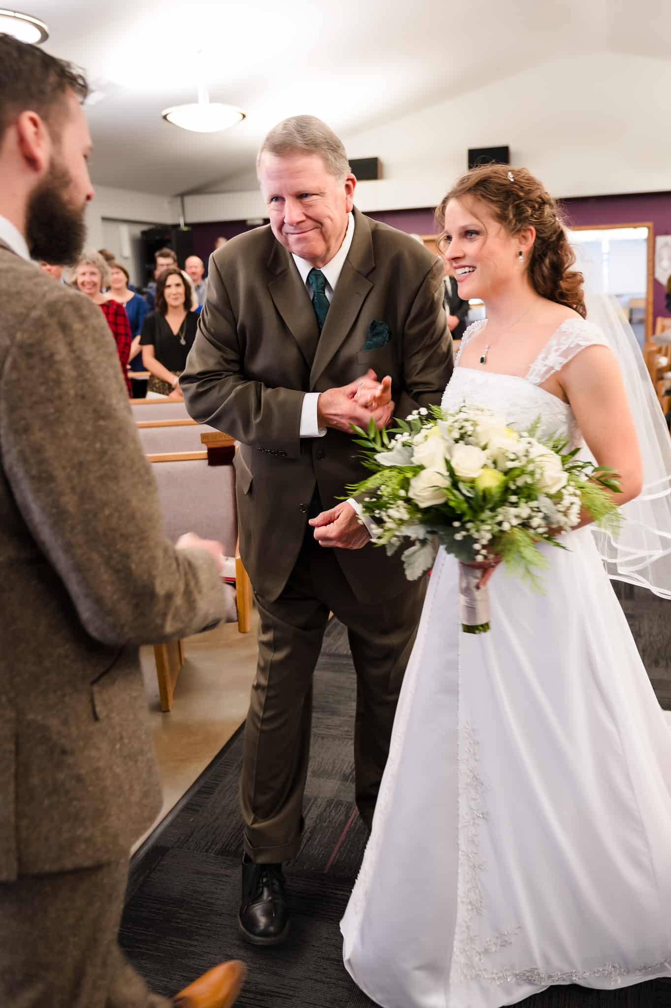 The father of the bride stops with his daughter in front of the groom.