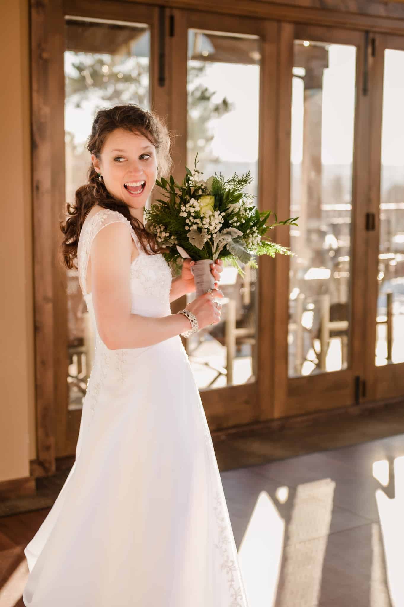 The bride in a sunny alcove prepares to throw her bouquet to the eligible single women in the flower toss.
