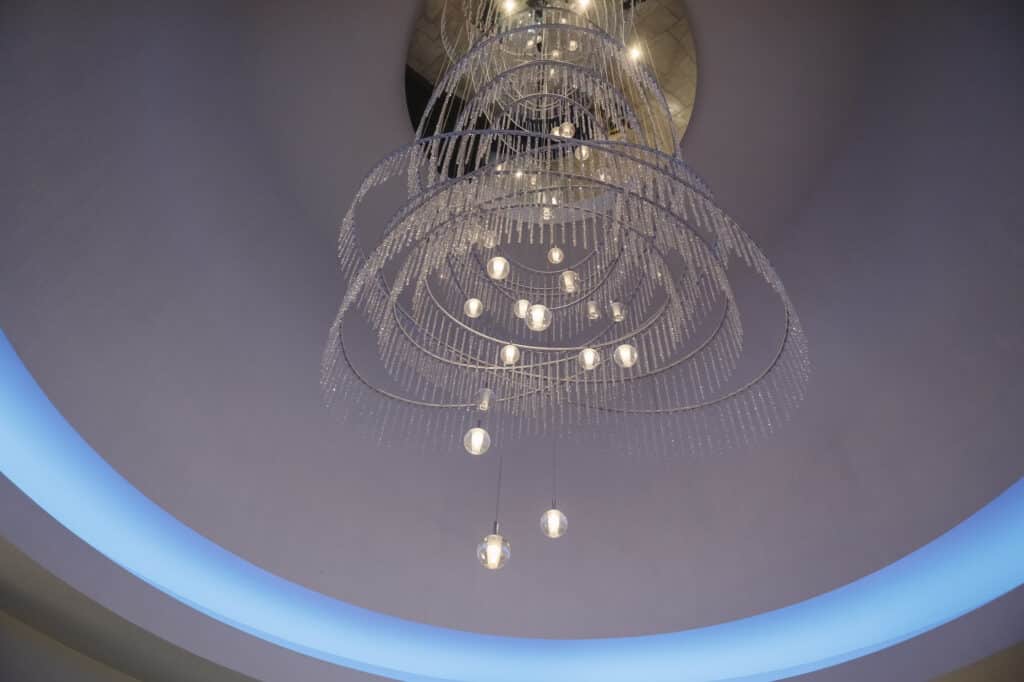 Beautiful crystal chandelier ringed by modern LED lighting that changes colors at Ashley ridge.
