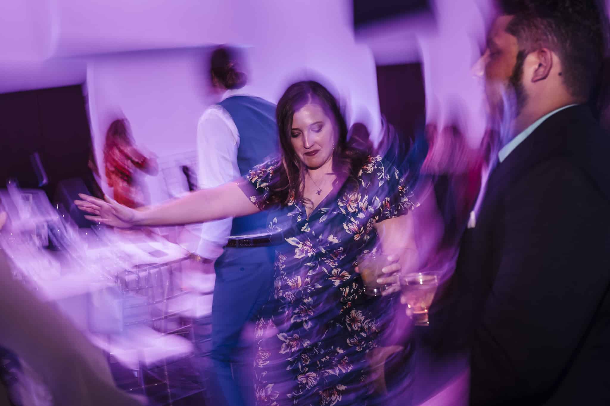 Motion blur of a woman dancing at a wedding.