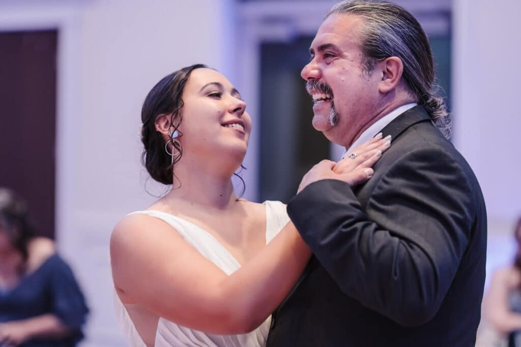 The bride and her father enjoy a dance together.