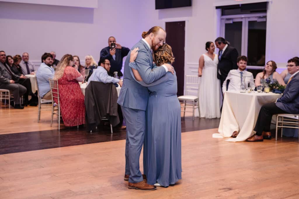 Mother and son share a dance at a wedding.
