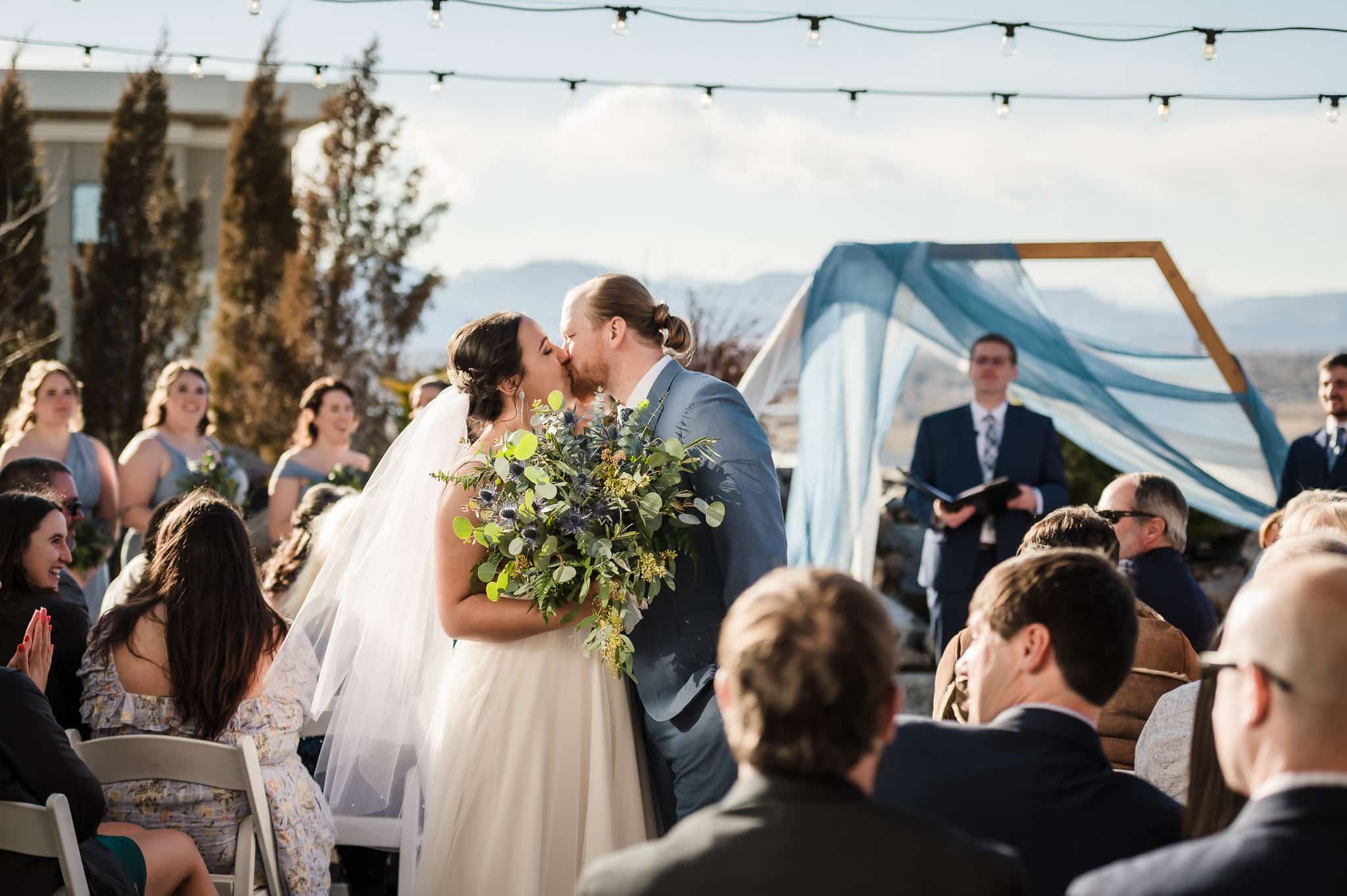 A second first kiss midway down the aisle at this outdoor spring wedding at Ashley Ridge.