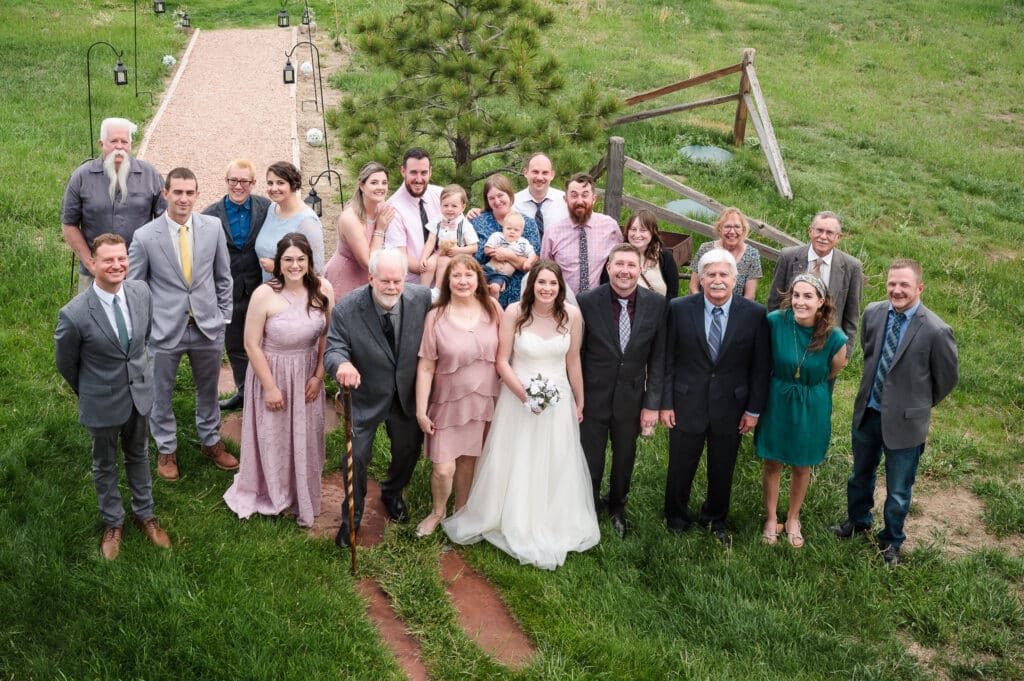 A balcony view of all the attendees present for an outdoor wedding in the rain.