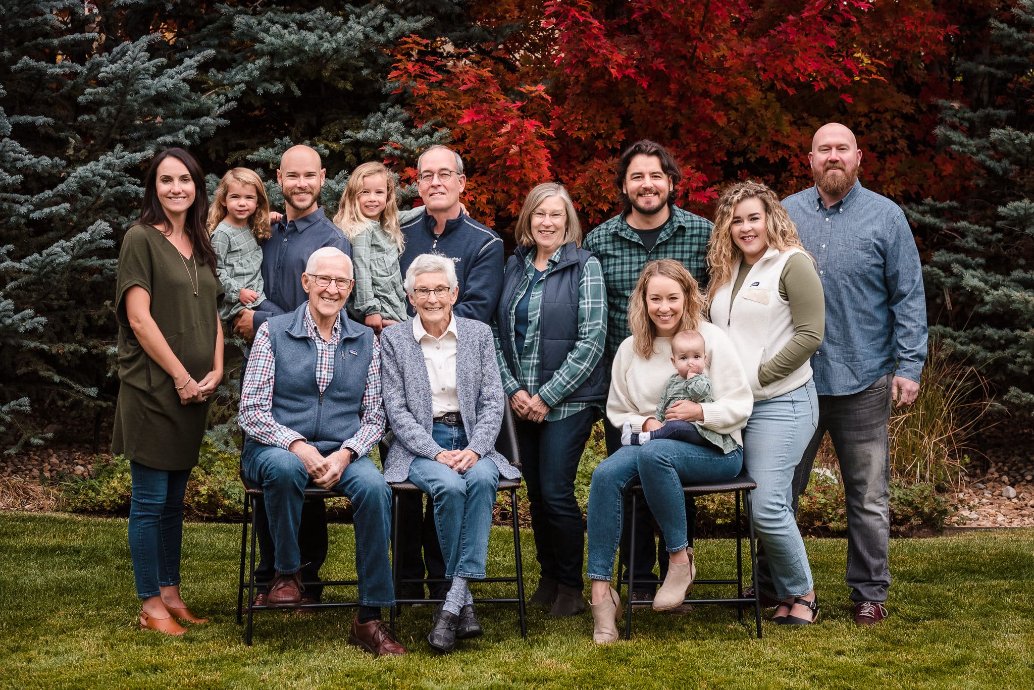 A large multi-generational group photo taken in a backyard in Littleton.