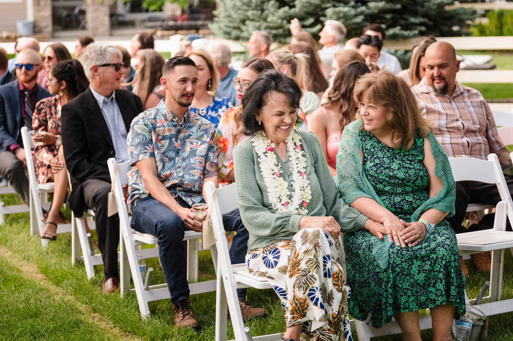 The guests talk amongst themselves and eagerly await for the wedding processional to start.