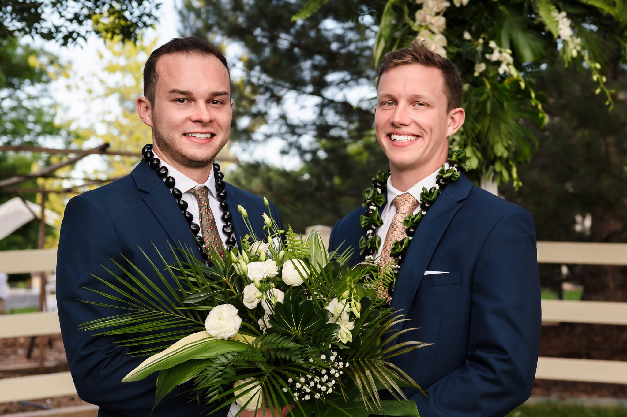 The groom and best man hold the wedding bouquet.