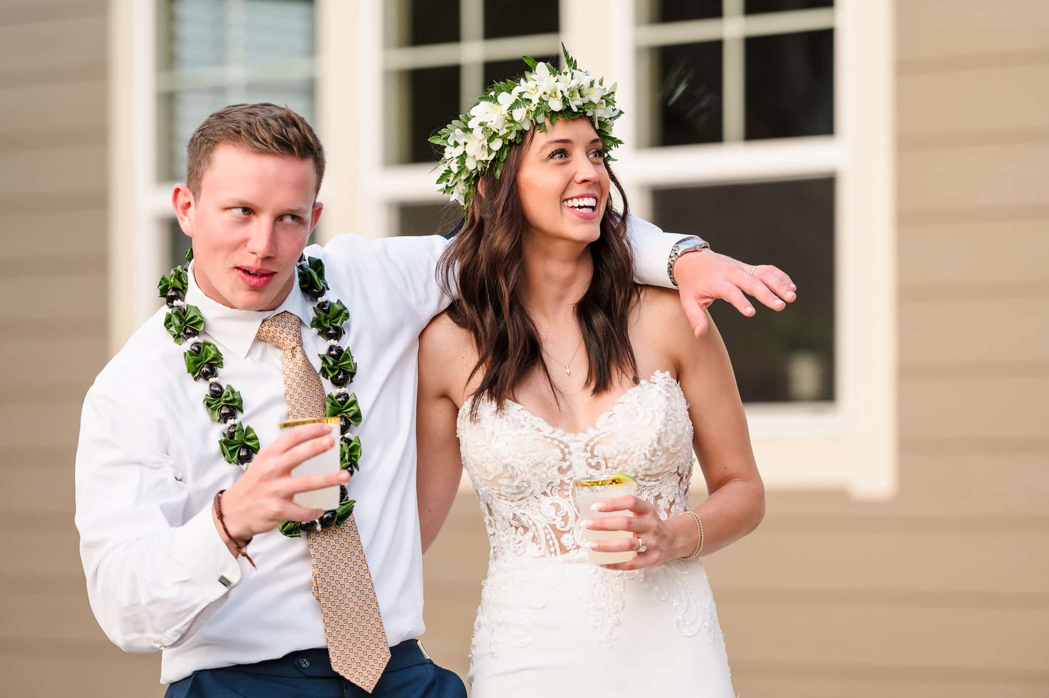 The groom and the bride react to the best man's toast.