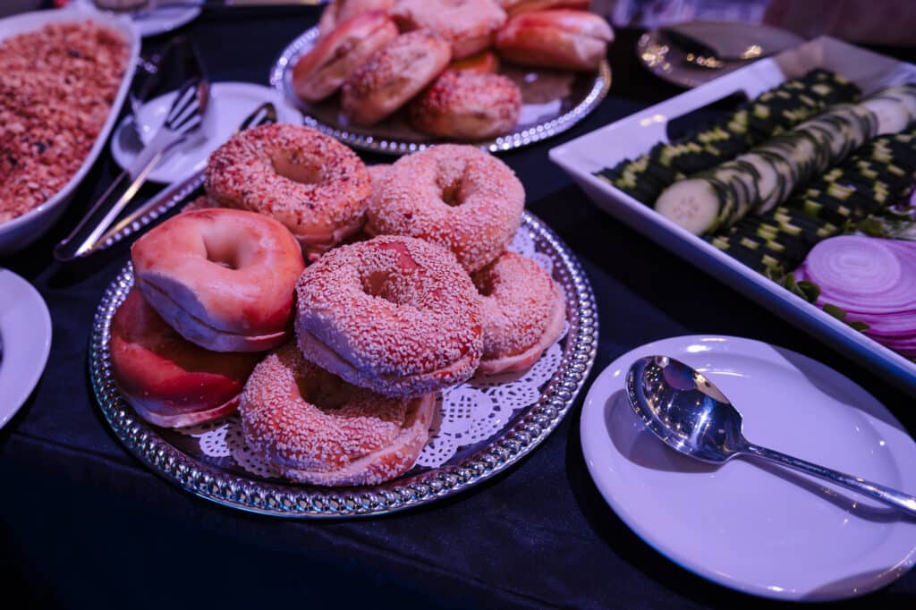 A plate of plain and sesame bagels at a brunch buffet.