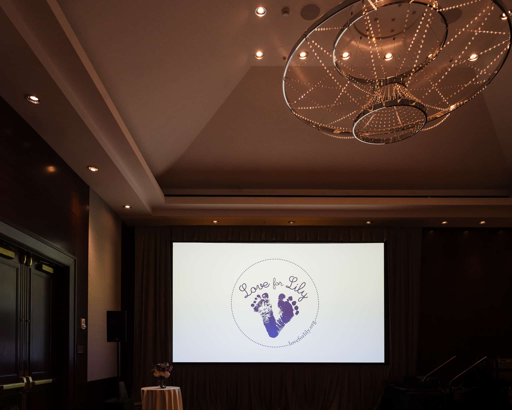 The entrance to the ballroom displays a Love for Lily Logo on the projection screen.