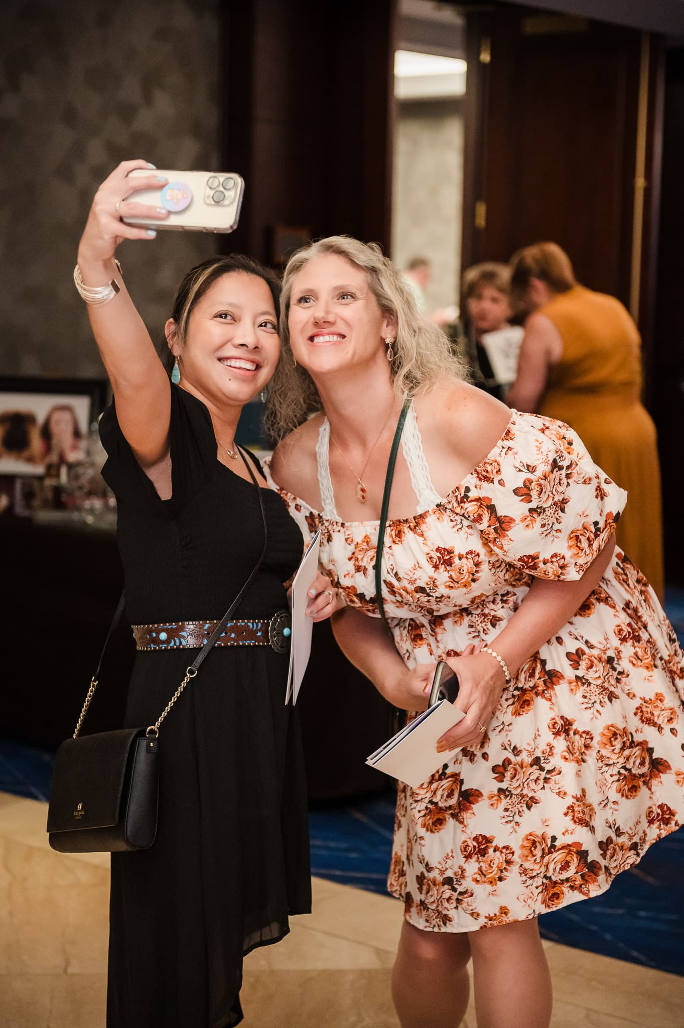 Two women take a selfie together at a charity event in downtown Denver.