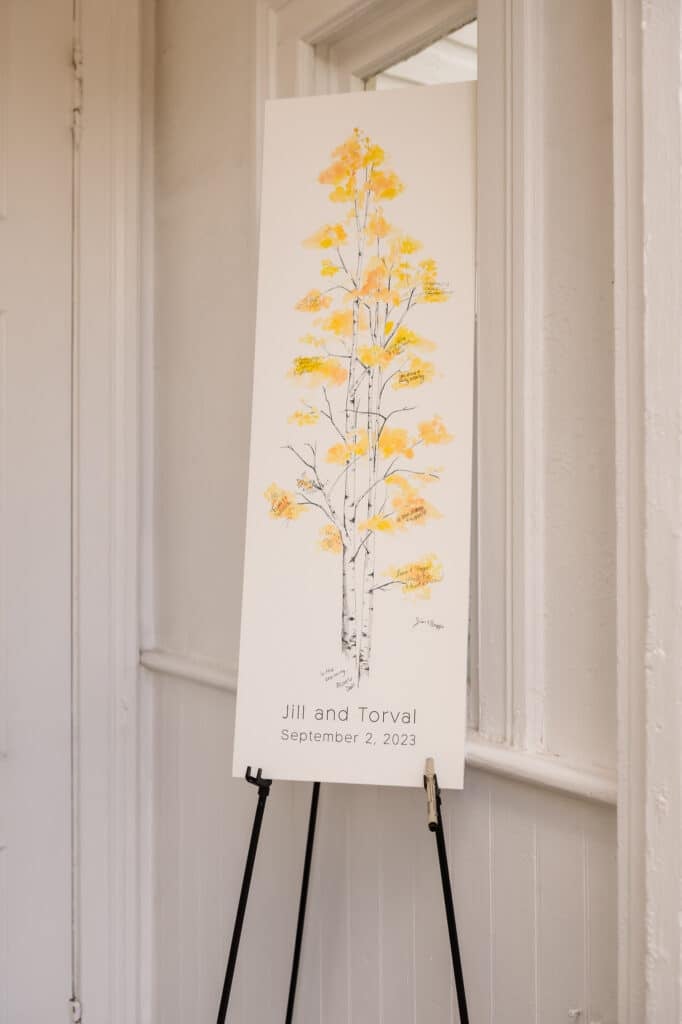 A large print of a golden-leaved aspen tree ready for guests to sign as a wedding instead of a traditional guest book.