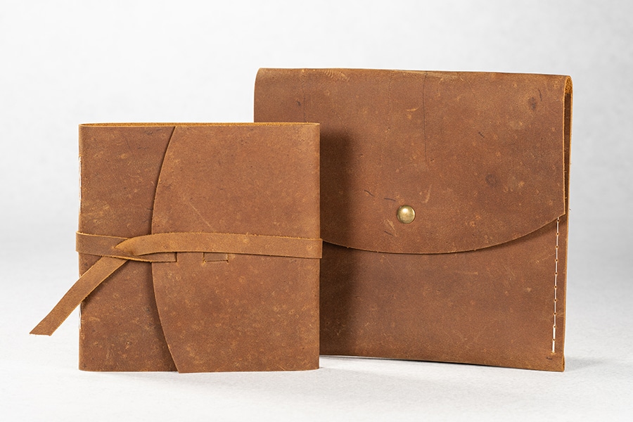 A leather wrap album shown with a rustic leather envelope.