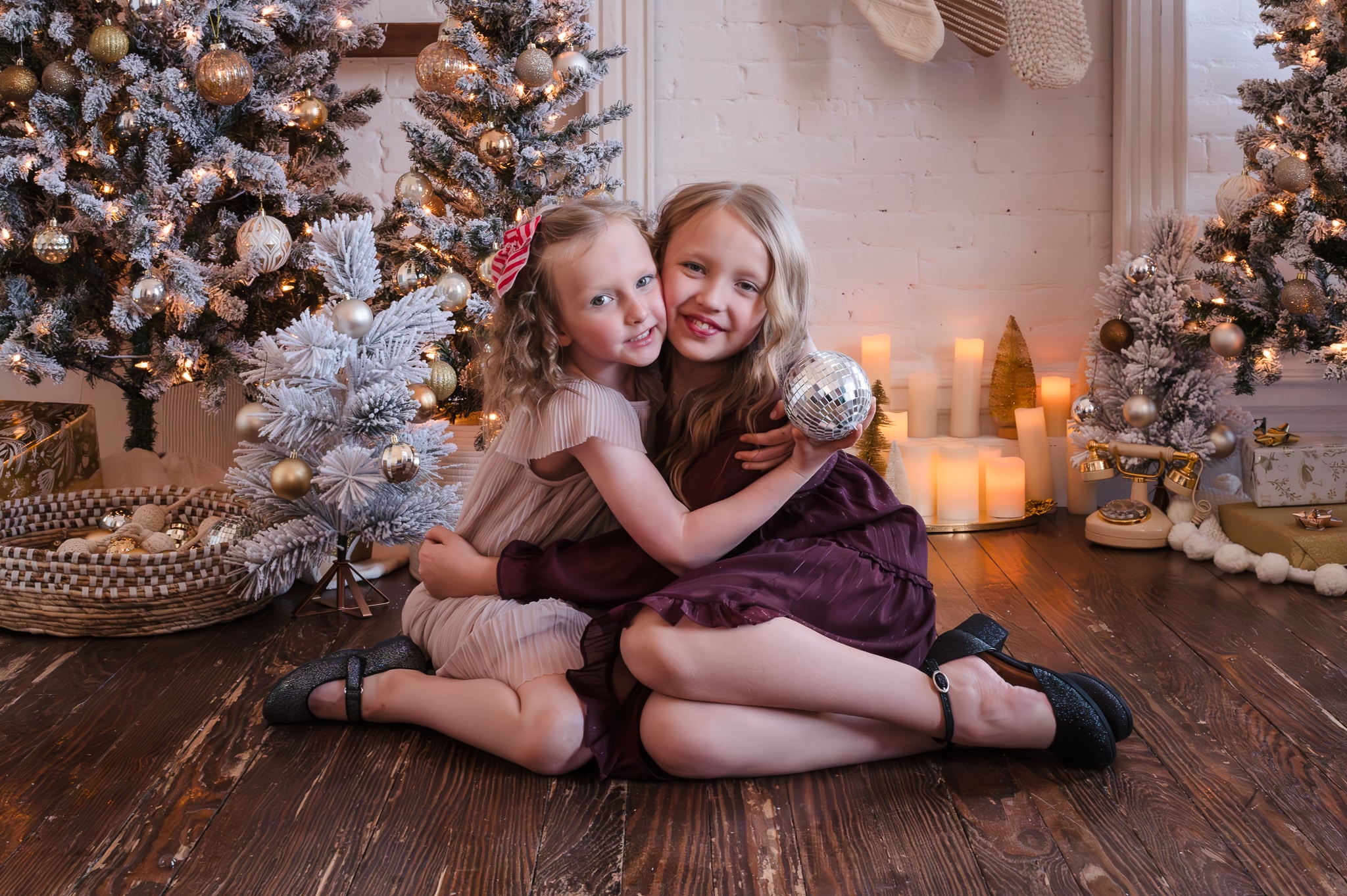 Holiday photo color schemes with jewel tones as shown on these two girls hugging make for a beautiful photo.