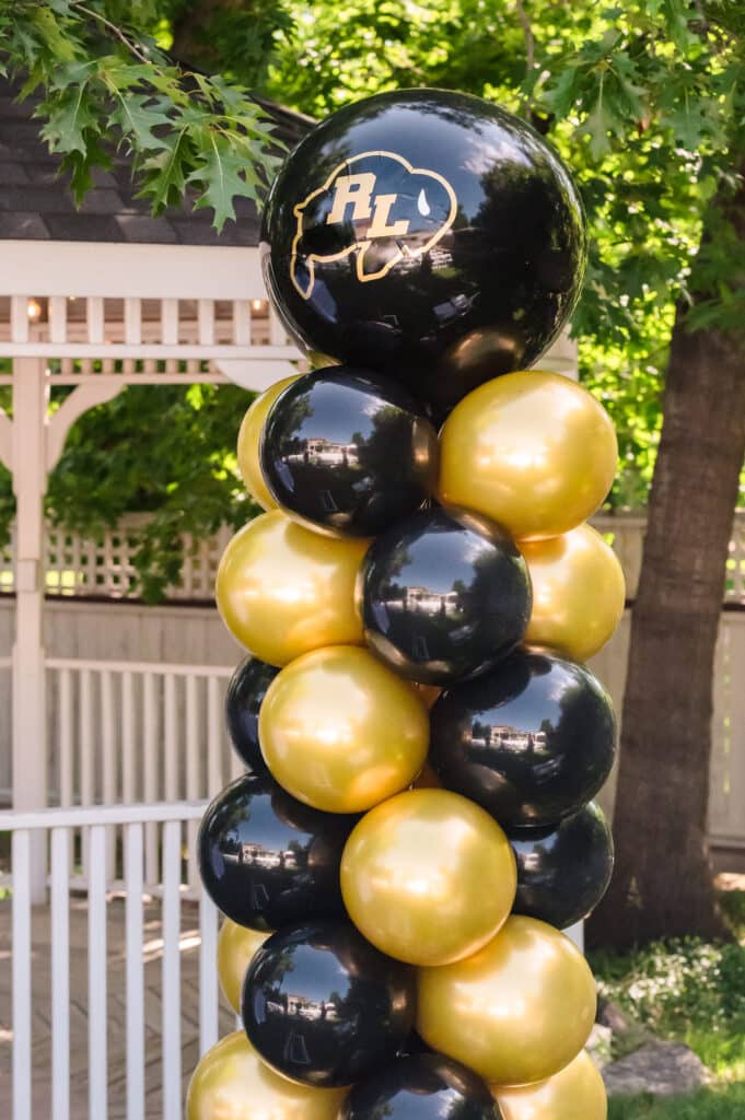 CU-Boulder inspired mitzvah decor includes balloons in gold and black.