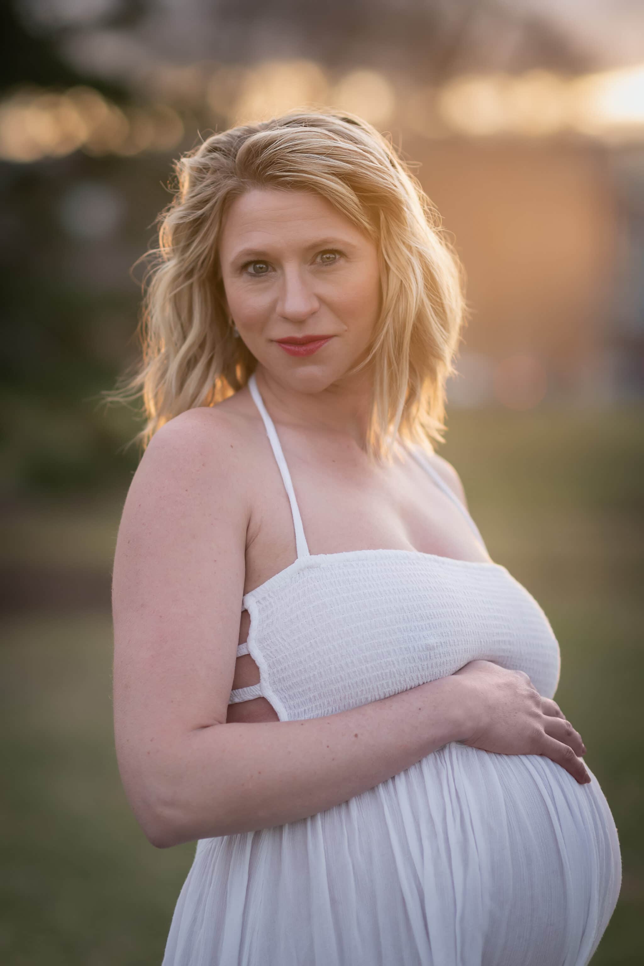An expectant mother lit with the light of the setting sun during a Denver maternity session.