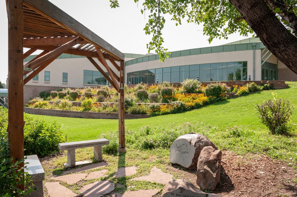 Exterior view of the Hebrew Educational Alliance and the beautiful landscaping on a sunny summer day.